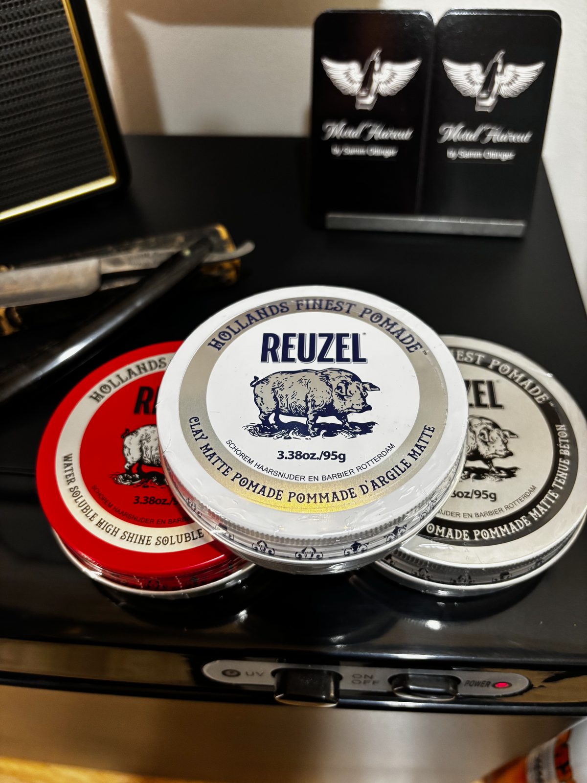 Pomade and styling product display at Metal Haircut