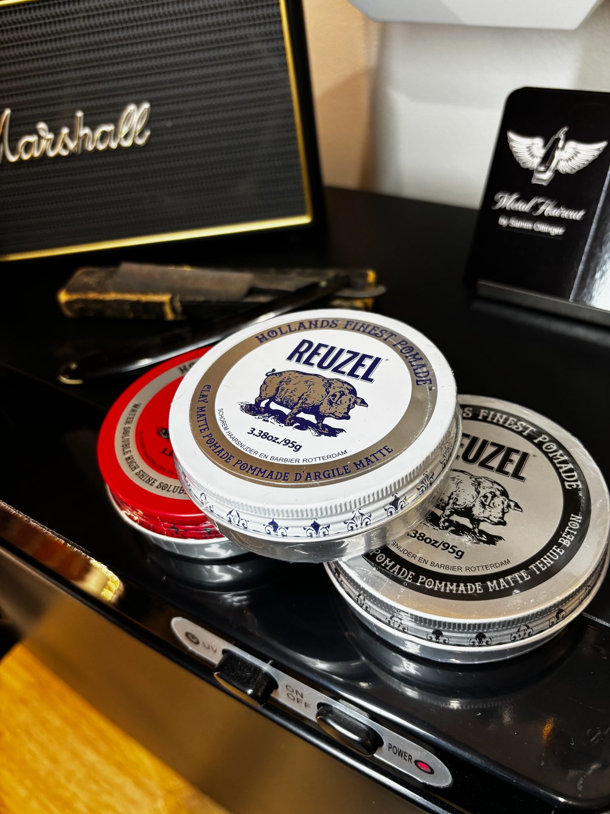 Close-up of styling products and tools on the shop counter